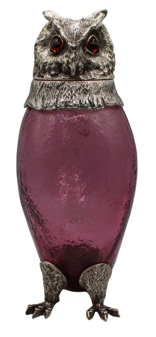 Silver-plated Amethyst Glass Owl Form Pitcher with: Brown Eyes. Amethyst colored glass pitcher with silver-plated tail, feet, and head with a clear glass handle. Decorated with strong detailed brown eyes. Circa 1970's. Plated in nickel silver with ille