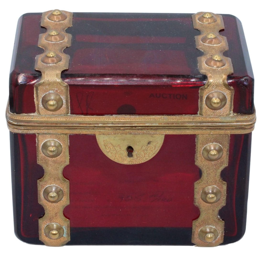 Brass Mounted Cranberry Glass Box.: Cranberry glass box with bronze studs decoration wrapping around the entire box. The box has a gilt bronze engraved lock system. From the estate of a 50+ year antique dealer specializing in decorative