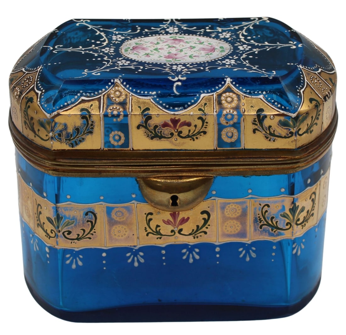 19th C Enamel and Gilt Decorated Blue Glass Hinged: Box. Blue glass box with gilt metal mounts and hardware. Decorated with gold and white enamel with pink & white flowers to the top of the lid. From the estate of a 50+ year antique dealer speciali