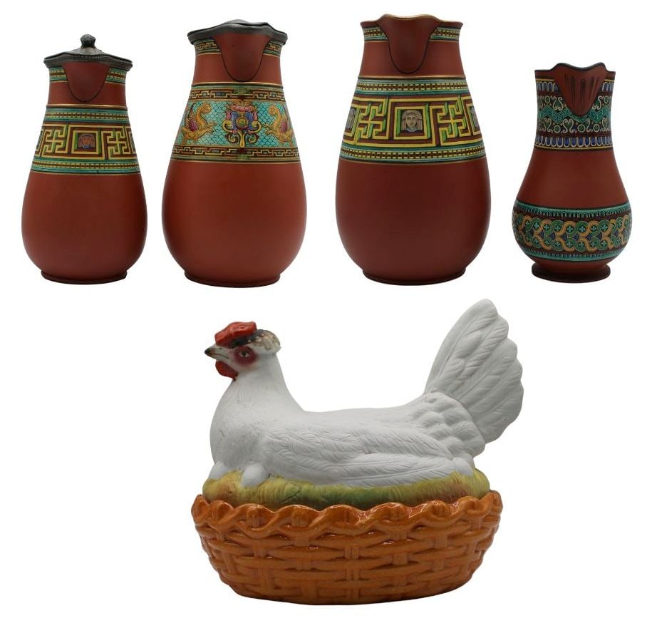 (4) Watcombe Pottery Jugs and (1) Hen and Nest: Box. Including a small pitcher with a multicolored geometric pattern and a face sculpted into the base of the handle; a small silverplated pitcher - stamped, "James Dixon & Sons Sheffield 18&