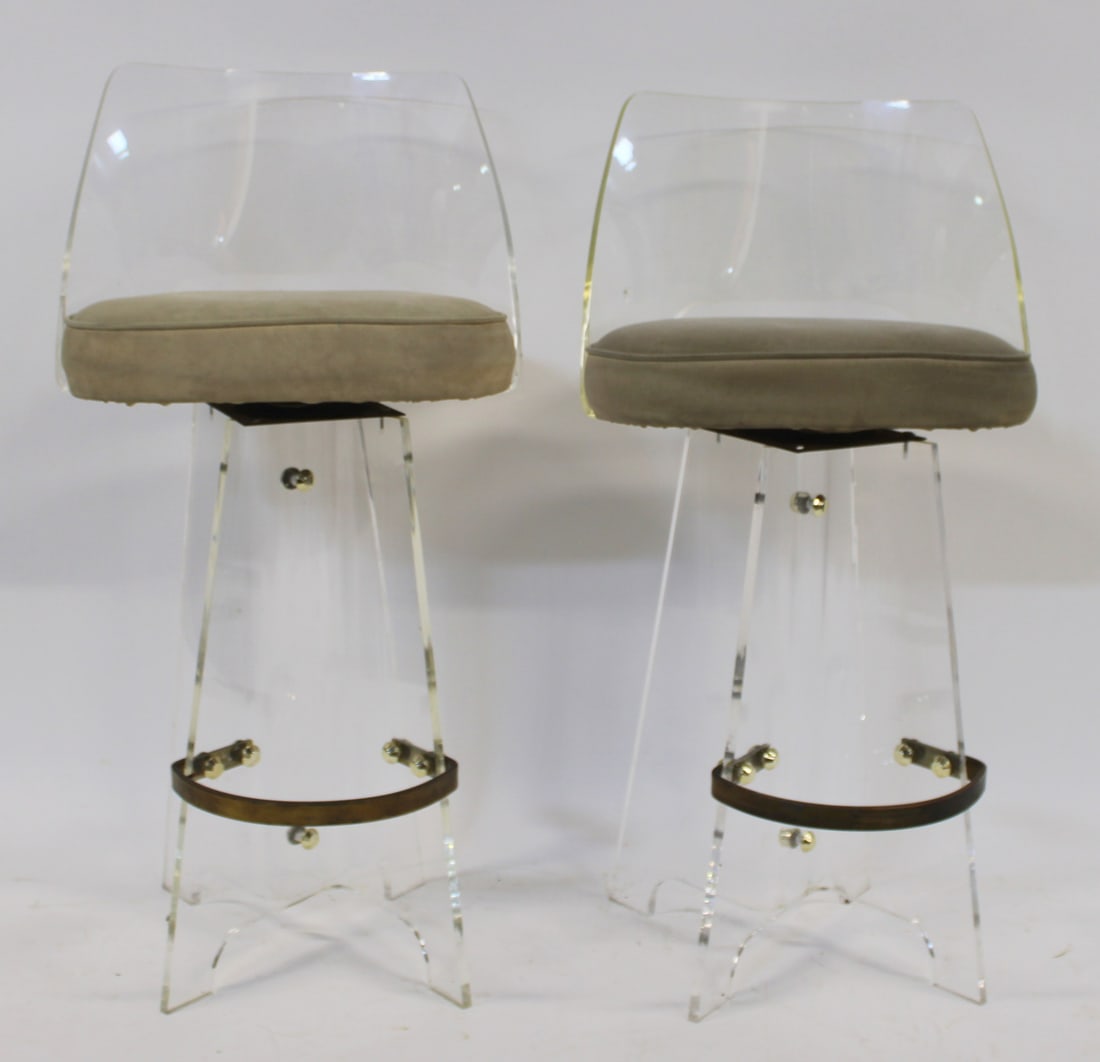 Midcentury Pair of Lucite Stools.: Both with brass footrest and they swivel. From the estate of a 50+ year antique dealer specializing in decorative arts with an emphasis on Opaline glass boxes.