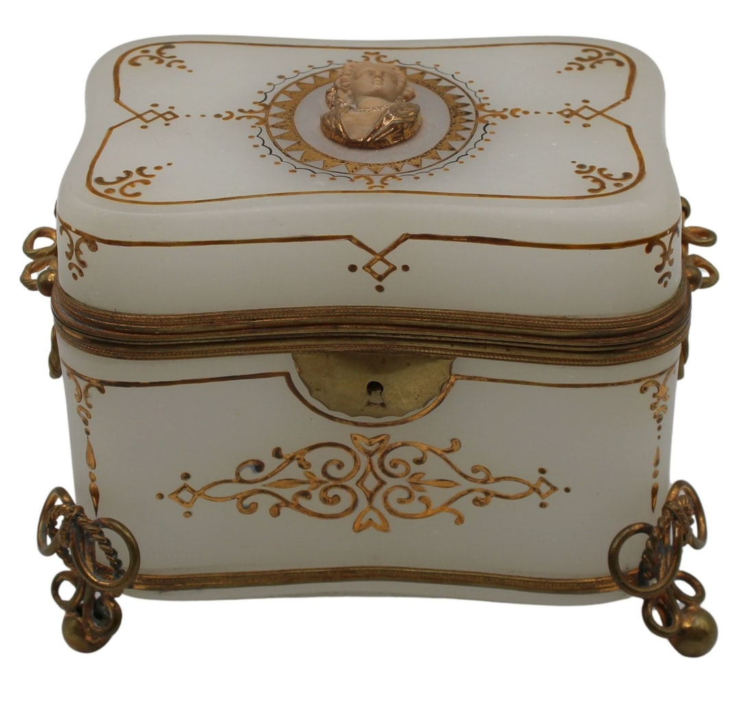 Antique Bronze Mounted White Opaline Glass Box: with Portrait. White opaline glass box with ring and ball form feet, accompanied by engraved mounts with a textured bust portrait on the center lid. Gold painted geometric designs throughout. Signed,