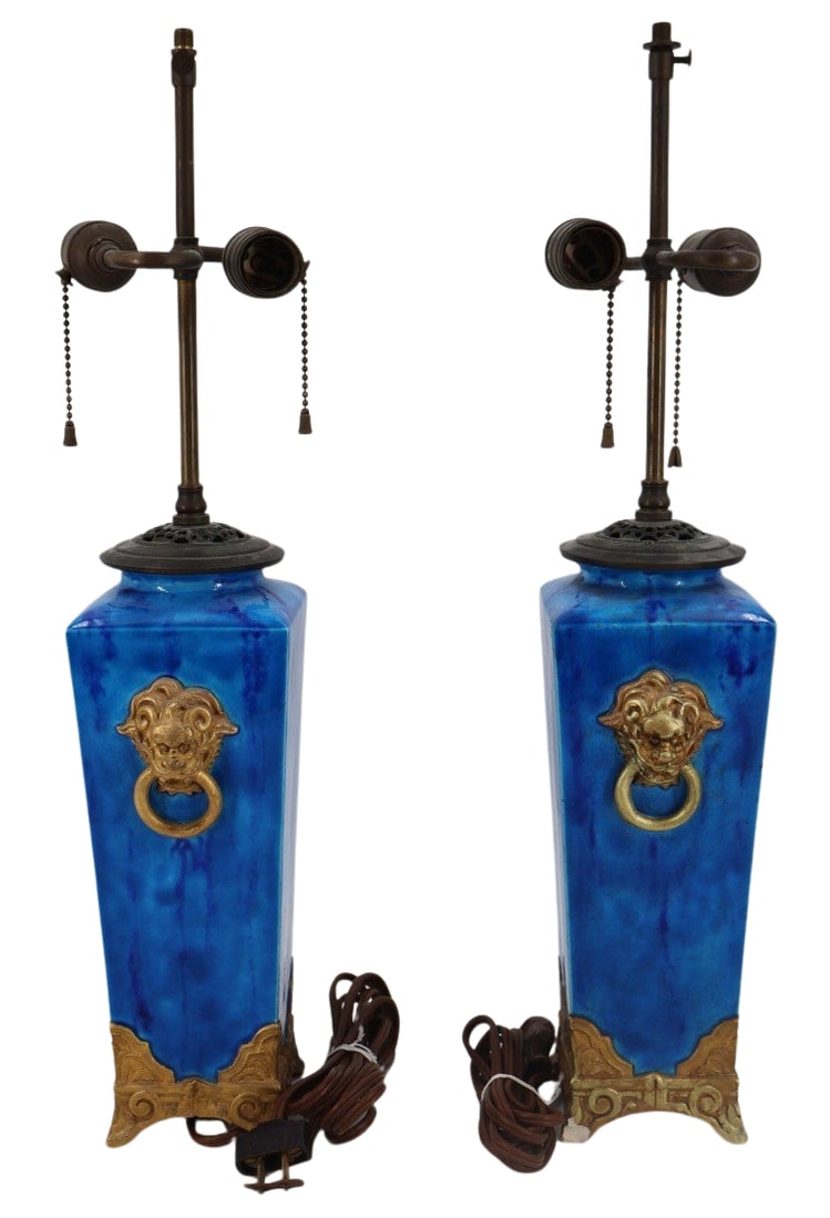 Vintage Pair of Asian Style Bronze Mounted: Porcelain Lamps. The lamps in a wonderful electric blue and with bronze mounted base and Foo Lion handles. From the estate of a 50+ year antique dealer specializing in decorative arts with an emphasis
