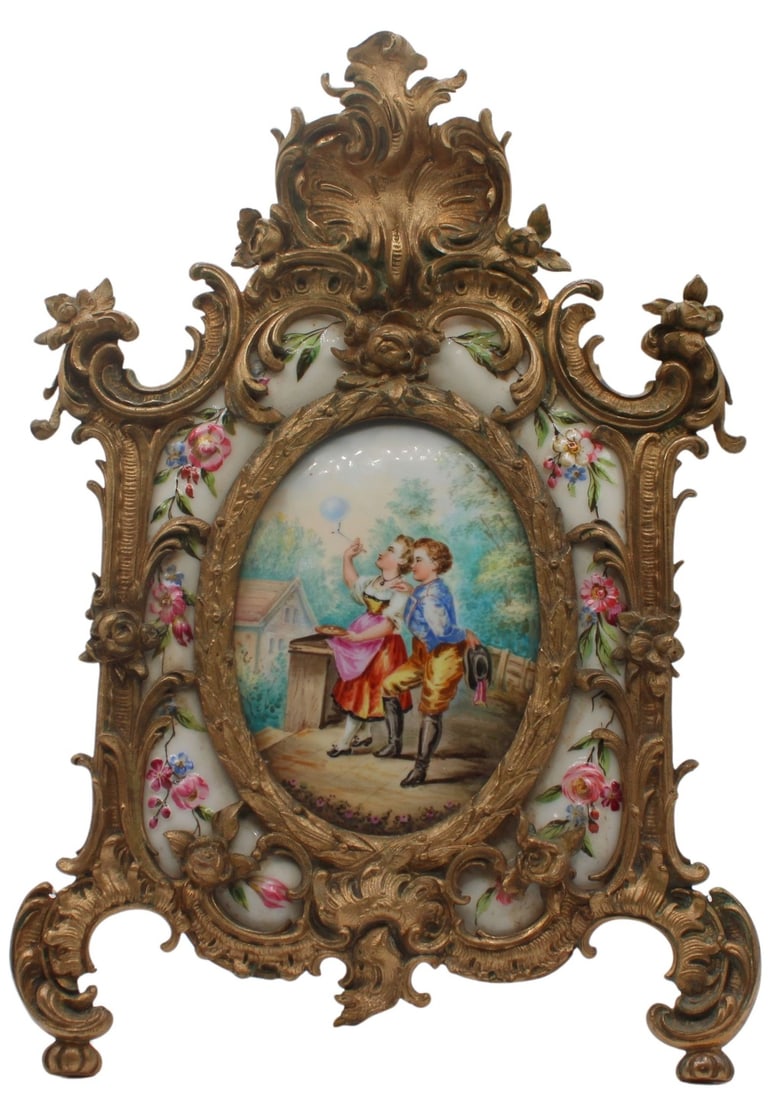 Antique KPM Miniature Painted Portrait Plaque in: an Ornate Gilt Bronze Frame. Painted plaque depicts 2 youth in the center accompanied by raised painted floral decorated porcelain plaques on each side - stamped, KPM verso of each accent porcelain. G