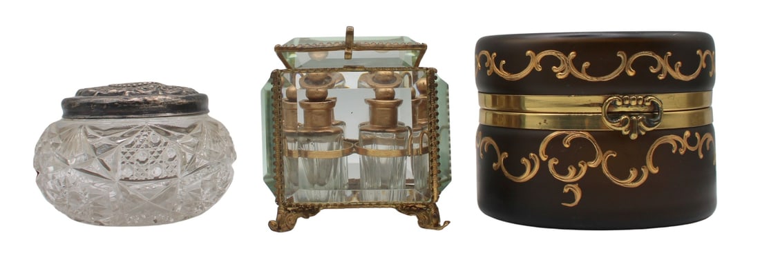 (3) Cut Glass Boxes with Metal Mounts.: Including a cut glass jar with a monogrammed sterling silver lid - stamped, "C.M.V." and "sterling" along the side with a scroll motif; a glass cube perfume casket with (4) small g