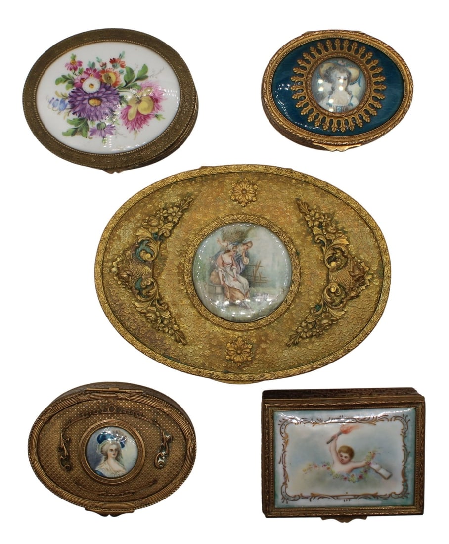 (5) Gilt Bronze Boxes with Painted Plaques.: Including a rectangle form box with a tied bow motif with a painted plaque lid of a youth holding fire; an oval form box with a floral motif with a painted plaque lid of flowers of various size,
