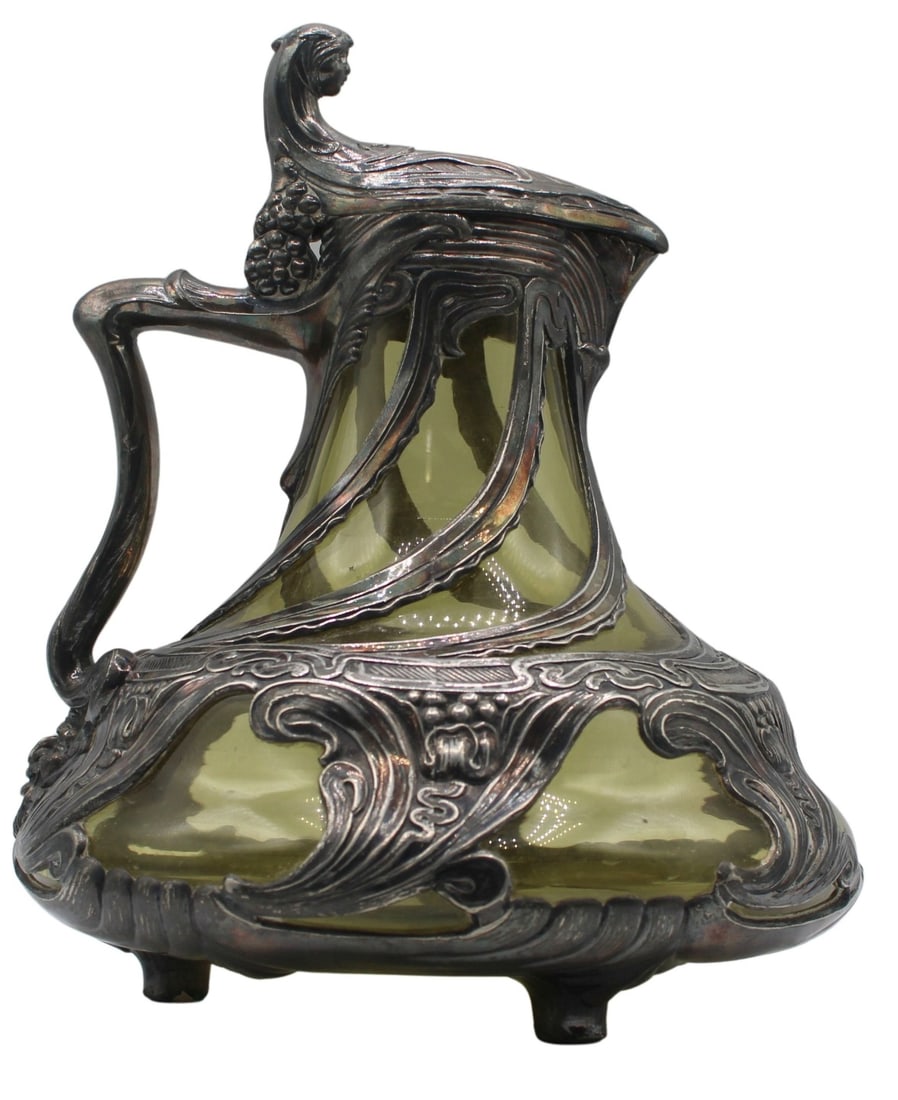 Art Nouveau Chartreuse Colored Glass and: Silverplated Pitcher. Silverplate overlay is decorated with a woman's face on the top of the lid as well as other intricate line work throughout. From the estate of a 50+ year antique dealer specializ
