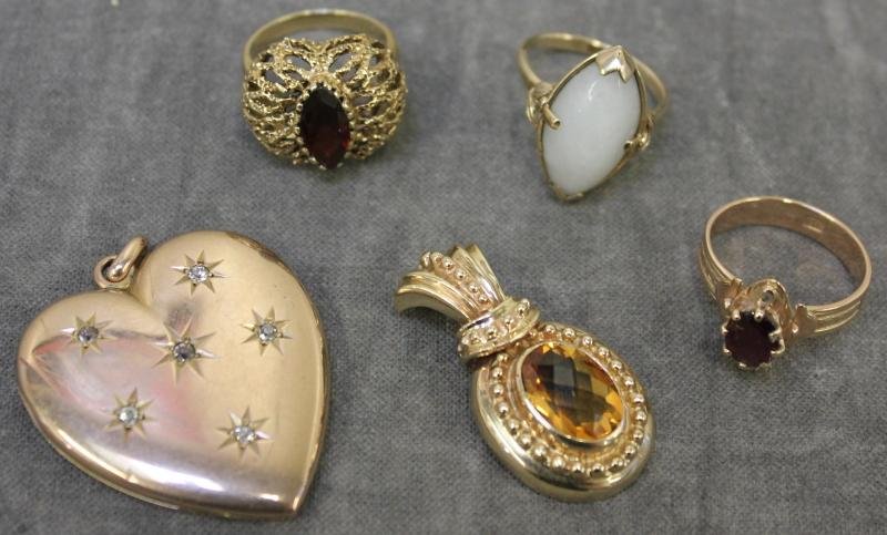 JEWELRY. 14Kt Gold Estate Jewelry.: Includes a Ming's white jade and 14kt yellow gold ring - size 7 1/4, a 14kt yellow gold and garnet? ring - size 7 3/4, a14kt yellow gold ring with red faceted center stone - size 6 3/4, an unmarked 14