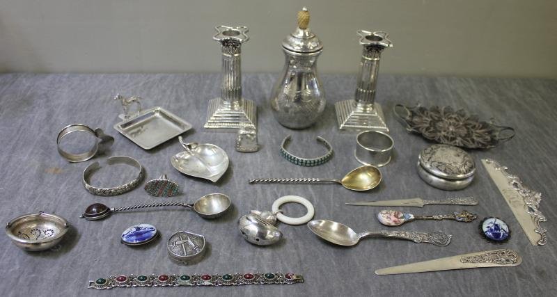STERLING. Large Miscellaneous Lot.: Includes 2 sterling candlesticks, a Tiffany leaf form bowl, a napkin ring, tea strainer, small dish with horse surmount, a bell, filigree handled tray, a small pill box with swords, duck rattle, a cru