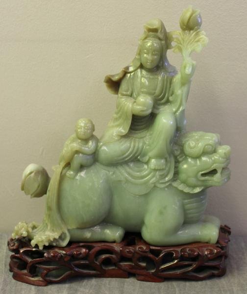 Vintage Chinese Jade Figure of Quan Yin Atop a: Foo Dog. On a hardwood base. From a Westchester, NY location. Dimensions: figure only - 7.5" wide x 2.75" deep x 8.75" high. Condition: Good.