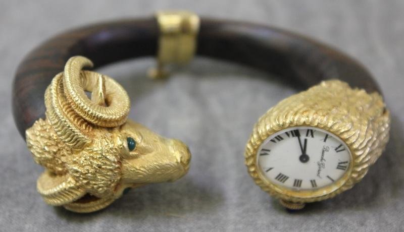 JEWELRY. Bueche-Girod 18kt Ram's Head and Wood: Watch or Bracelet. With emerald cabochon eyes. Watch model # YG7755.1, and serial # 85594. Total approximate weight is 54.2 dwt. From a Manhattan, NY estate.