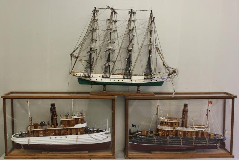 Ship Model Lot Includes N.Y.F.D. Model Titled: "Staten Island" by Jay Holt, Another Titled "John Dock," also by Jay Holt. Each of these in custom wood and plastic cass with overall 19.5" h x 33" w x 8.5" d. Also includes another freestanding model