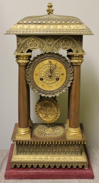 Charles X Gothic Revival Gilt and Patinated Clock.: From a Great Neck Long Island, NY estate. Dimensions: 8.375" w x 4.675" d x 17" h.