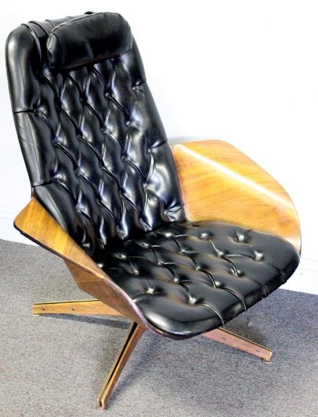 Midcentury George Mulhauser for Plycraft Lounge: Chair. With tufted leather cushion and bentwood arms. From a Long Island, NY estate. Dimensions: 36" w x 33" d x 30.5" h. Condition: Seemingly repaired to rear of seat. Sold as is.