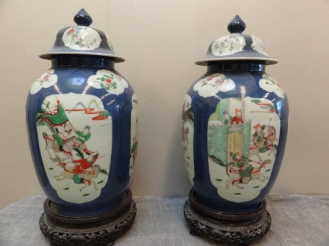 Pr Of Antique Blue Background Lidded Ginger Jars: With Famille Verte Battle Scenes and on non matching stands . From A Heritage Hills NY collector . Dimensions: 17"diax 5.5"base8.5"middle Condition: one rim with old repair same lid with repair
