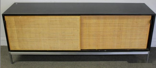 Florence Knoll Midcentury Sliding Door Credenza.: A signed and rare laminate Knoll unit with grass cloth sliding doors and leather pulls. Signed on the back. Lock on top left corner. From an Englewood, NJ estate. Dimensions: 69" w x 18" d x 27" h. Co