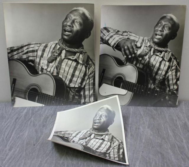 ABBOTT, Berenice. 3 Photographs of Lead Belly.: Berenice Abbott, American, 1898-1991. From a Briarcliff Manor, NY estate. Dimensions: 13.125" h x 10.5" w and 9.875" h x 8" w. Condition: Some warping to photo paper of smaller image; Blue ink? splotc