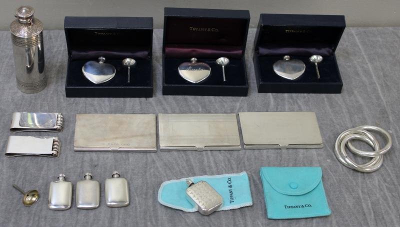 STERLING. Tiffany Accessories Grouping.: Includes 3 cardholders, a snuff bottle necklace, 2 Paloma Picasso money clips, 3 heart shaped perfume bottles in fitted boxes, Tiffany teething rings, 3 perfume bottles and one funnel, and a covered v