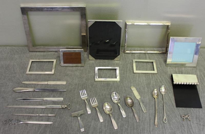 STERLING. Miscellaneous Tiffany & Co. Grouping.: Includes 8 frames of various sizes, a Tiffany & Co. sterling bow form brooch, 6 letter openers, a Paloma Picasso notebook holder?, 3 child's spoons, 2 child's forks, a baby push, a child's knife, and 