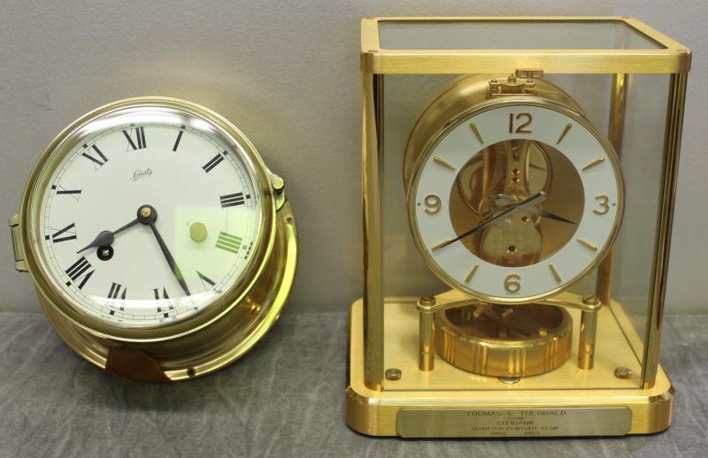 Jaeger Le Coultre Atmos Clock.: With plaque inscription. Serial number 615150. With a Schatz ships style clock. From a Greenwich, CT estate. Dimension: ships clock - 6" diameter x 4" deep.