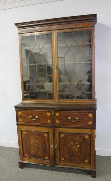 19th C Georgian Style Mahogany Secretary Bookcase.: An extra grade bookcase with inlaid doors and a Prince of Wales plume inlaid crown and maple inserts. From a Hartsdale, NY estate. Dimensions: 47" w x 22" d x 89" h. Condition: Good.