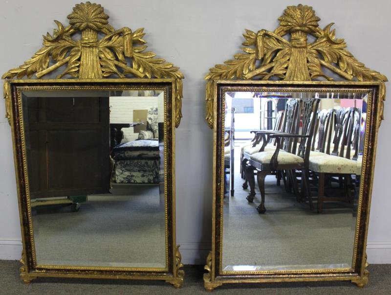 Pair of Vintage French Style Gilded Mirrors.: Carved with nice sheaf of wheat and farm tool crest. Inner border with faux tortoise shell grain paint. From a Long Island, NY estate. Dimensions: 52" h x 31.75" w. Condition: Good, some areas of loss