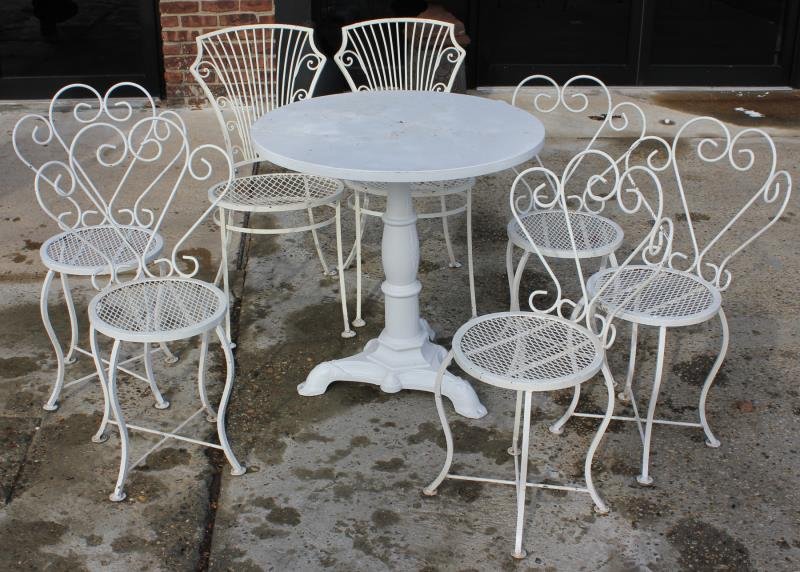 Wrought Iron Lot Including 7 Chairs and Cast Iron: Ice Cream Parlor Table. 5 ice cream chairs and 2 others, together with a cast iron center table. From a Connecticut estate. Dimensions: 5 Chairs - 18" w x 16" d x 31.5" high; Other 2 - 16.5" w x 21" d