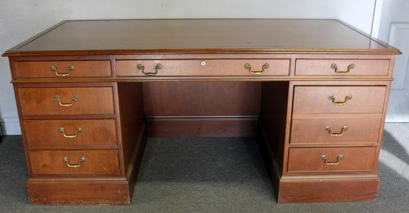 Kittinger Mahogany Executive Desk.: With metal label and burnt mark. From a Connecticut estate. Dimensions: 36" d x 30" h x 72" w. Condition: Scratches and abrasions to top.