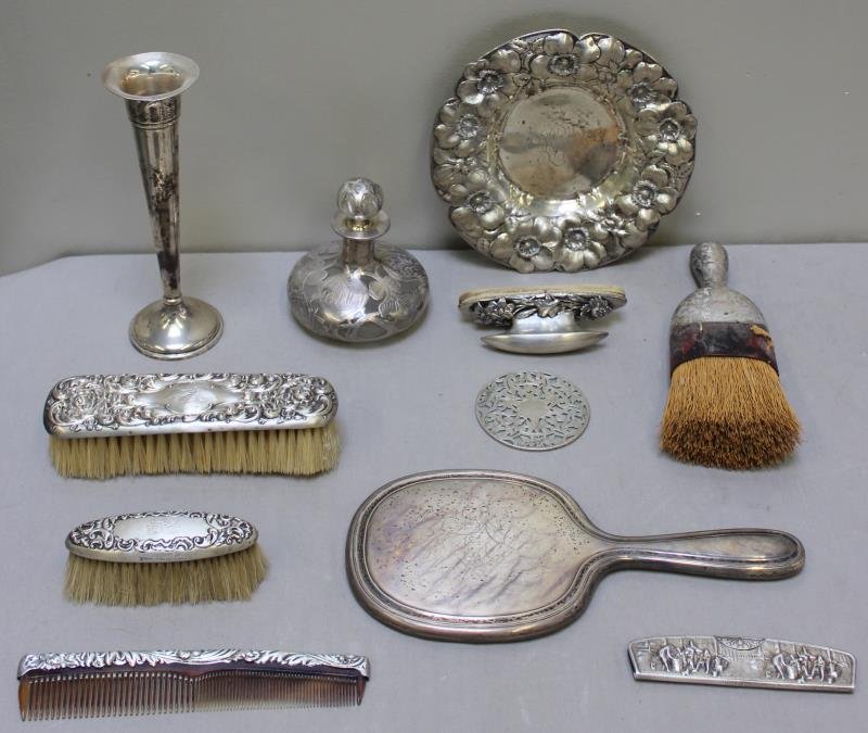 STERLING. Miscellaneous Silver Group.: Includes a large and a small brush; a hand broom; a Preisner weighted trumpet vase; a Tiffany & Co. hand mirror; a silver overlay perfume bottle; a floral nail buffer; a floral repousse bowl; a silver