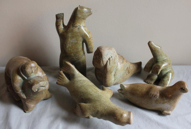 6 Piece Inuit Animal Carving Lot.: Includes a man riding a walrus, a standing bear, a walrus on side, a seal woman, and a seated walrus. From a West 57th St. NYC estate. Dimensions: Rider - 11" w x 7" h; bear - 13" h; walrus on side - 
