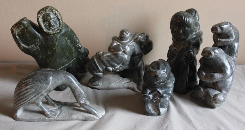 6 Piece Assorted Inuit Lot.: Includes a Bird with fish - 10" w x 5.5" h, a man with supplies - 9" w x 11.5" h, a kneeling boy - 5" w x 7" h, a man fighting with fish - 9" w x 8" h, an old woman with fish - 7" w x 11" h. From a We