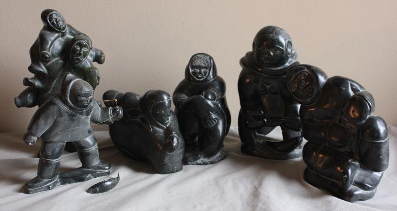 6 Piece Figural Inuit Lot.: Includes a man with fishing line and fish - 8" w x 9" h, a father and son - 9"w x 13" h, a man laying down - 11" w x 7" h, a seatd boy - 7" w x 9" h, a boy feeding a seal - 6" w x 10" h. From a West 5
