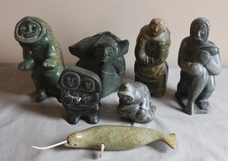 7 Piece Assorted Inuit Lot.: Includes a narwhale - 11" w x 4" h, an inuit yoda - 8" w x 8" h, a two headed figure - 8" w x 5" h, a figure in hood - 9" w x 11" h, a figure kneeling with seal - 4" w x 7" h, a man standing with seal