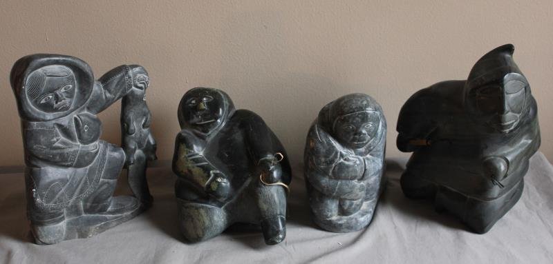 4 Piece Figural Inuit Lot.: Includes a hunter with fish and otter - 9" w x 13" h, a man kneeling - 10" w x 11" h, a man with fish - 8" w x 9" h, and a man with line - 9" w x 12" h. From a West 57th St. NYC estate.