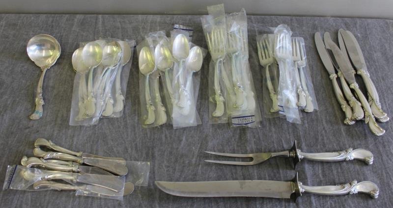 STERLING. Wallace "Waltz of Spring" Flatware Set.: Includes 7 butter knives, 6 dinner knives, 8 salad forks, 8 dinner forks, 8 soup spoons, 8 teaspoons, a ladle, and a carving set. In fitted wood case. Total approximate weight is 49.66 troy oz, exclud