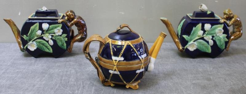 Antique English Majolica Teapots Lot.: Includes two with monkey handles, and one with rope bound and belted type. All with English registration marks. From a Croton, NY home. Dimensions: monkeys - 9.5" in length x 6.5" high; globular - 8" 