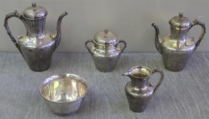 STERLING. Tiffany & Co. Mid 19th C 5 Piece Tea Set: Circa 1854-1870, maker John C. Moore. Includes a teapot, coffee pot, sugar, creamer, and waste vessel. With beautiful etched design and floral finials. Total approx. weight of all items is 85.42 troy