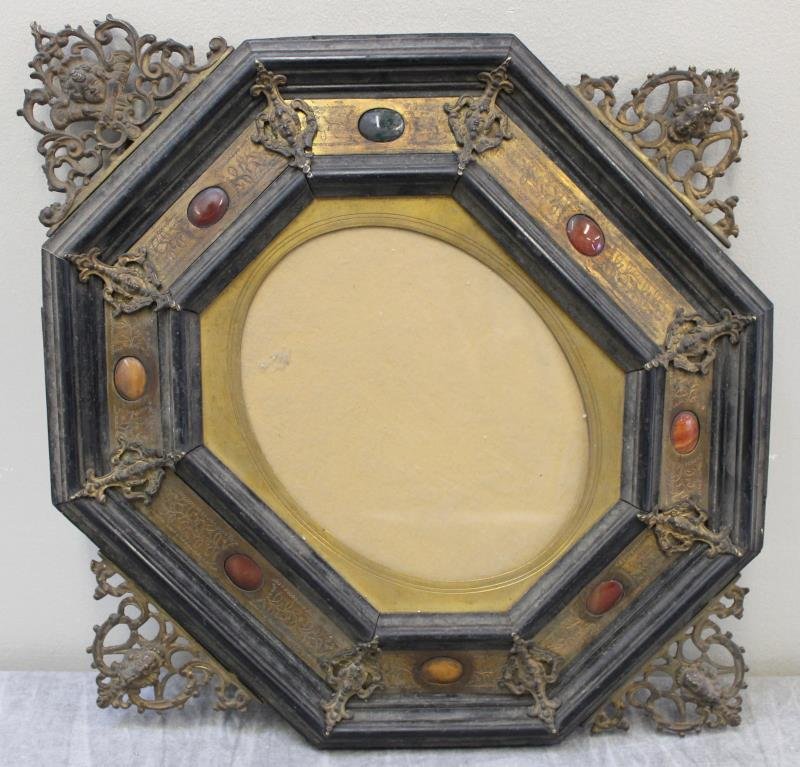 19th Century Continental Bronze/Brass Mounted: Ebony Frame. With inset hardstones. Probably for a painting on ivory. Dimensions: overall - 17.5" w x 20" h; interior oval - 5.75" w x 9" high. Condition: Very dirty; one bronze side mount loose.