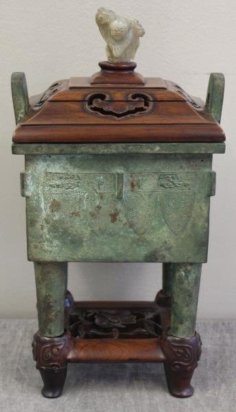 Vintage Chinese Bronze Archaic Style Censor.: On a quality conforming hardwood base, and top. With an antique white jade figure of a man. From an East 62nd Street Manhattan, NY estate. Dimensions: overall - 7" w x 5.5" d x 13.875" h; jade only - 