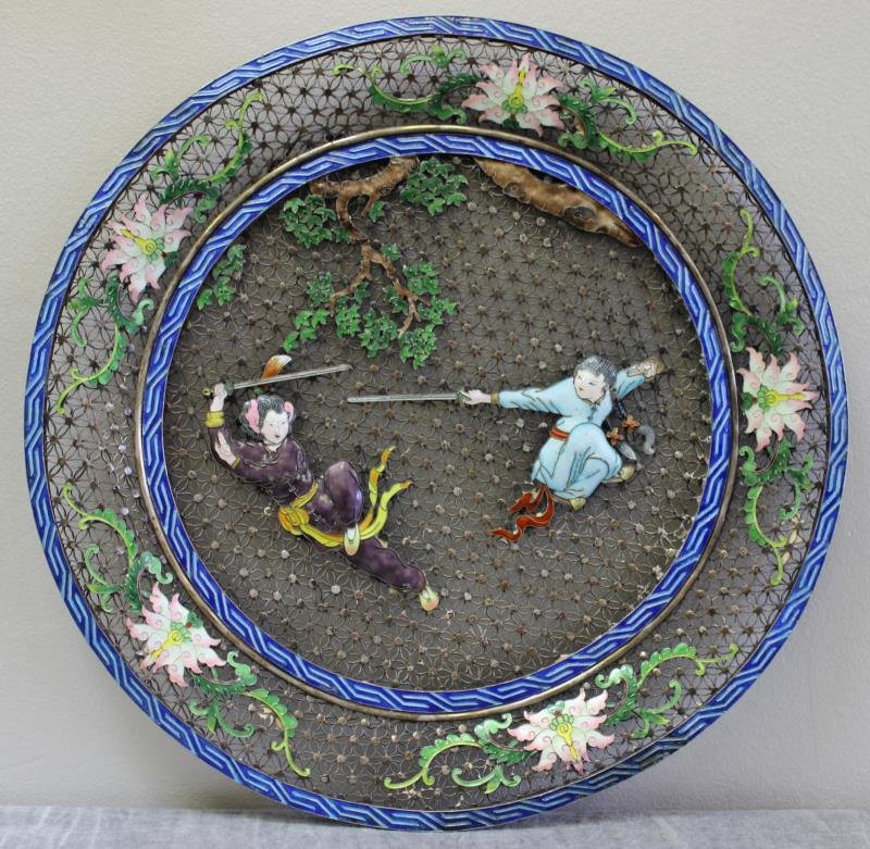SILVER. Chinese Silver and Enamel Filigree Charger: With central enamel decorated figures sword fighting, and lotus flower design to edge. Signed with Chinese characters on interior edge. Total approximate weight is 26.16 troy oz. From a Greenwich, CT