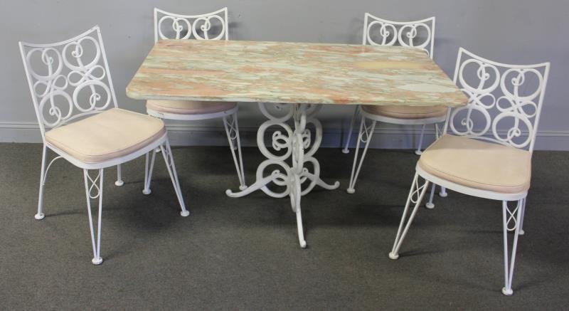 Woodard Outdoor Set Including Marble Top Table.: Rectangular pink marble top on single pedestal iron table with 4 matching chairs. Signed Woodard to plaque on chairs. From an East Hampton, NY estate. Dimensions: Table - 52" w x 32" d x 28" h; Chairs