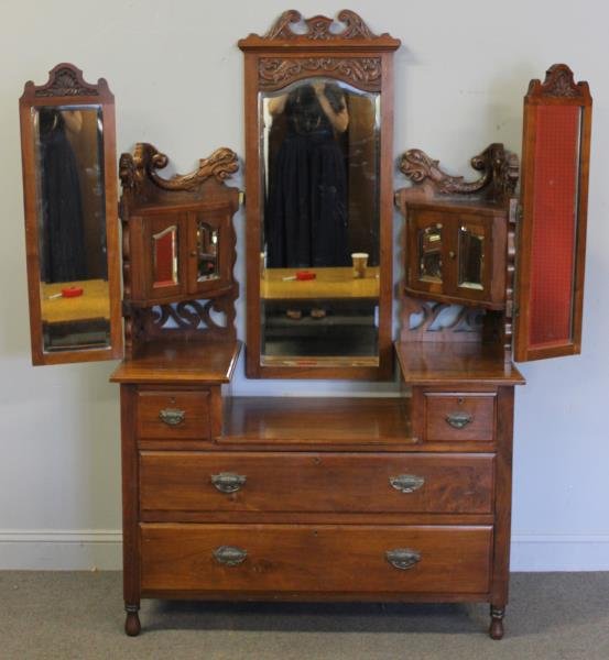 Edwardian Walnut Dressing Table.: With fold out mirrors, beveled glass, corner cubbies, and griffin carving. From a Larchmont, NY home. Dimensions: 45" w x 19.75" d x 71" h. Condition: Good, original condition. One brass hinge needs a