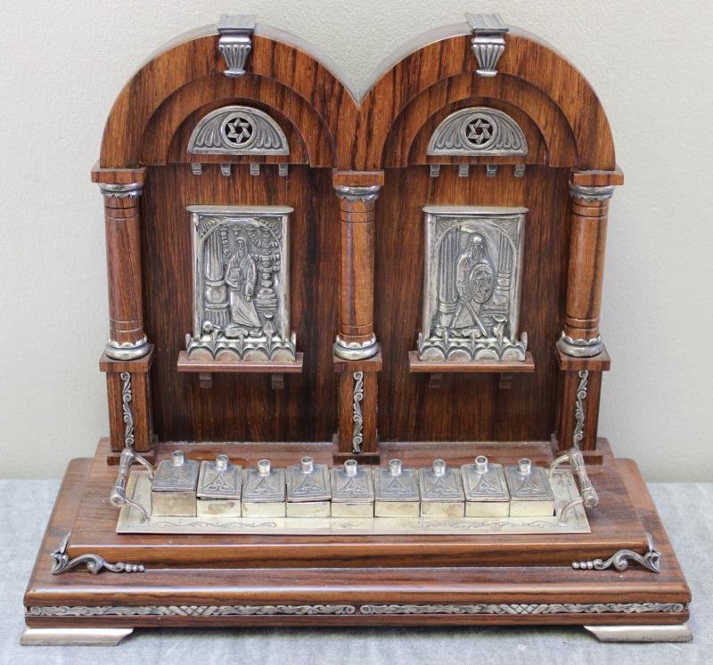 JUDAICA. Sterling and Olivewood Oil Burning: Menorah. With removable lamp part weighing approx. 8.3 troy oz. Apparently unmarked. From a Mamaroneck, NY estate. Dimensions: 8.75" w x 3.675" d x 7.5" h.