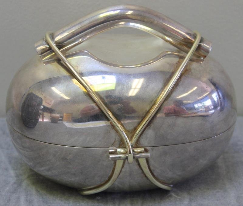 JUDAICA. Modern Sterling Etrog Box.: Designed by Arie Ofir. Signed on the bottom, "Stering," and "Arie Ofir," in English and Hebrew, as well as Israel. Box in the shape of an etrog with crossing gilded bands. Total approx. weight is 20.2