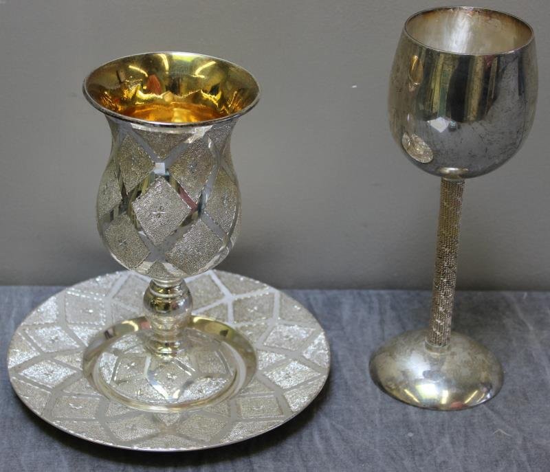 JUDAICA. Sterling Silver Kiddush Cup Grouping.: Includes a modern sterling silver Kiddush cup, marked, "sterling" on base with a maker's mark. Together with a sterling silver Kiddush cup and underplated decorated with a bright cut design, and marke