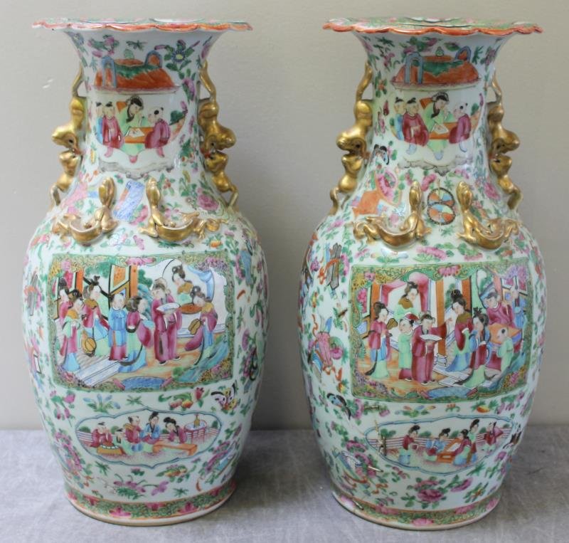 Pair of Antique Chinese Rose Mandarin Vases.: With gilt foo dogs and lizards. From a Manhattan, NY location. Condition: One with significant staple repairs.