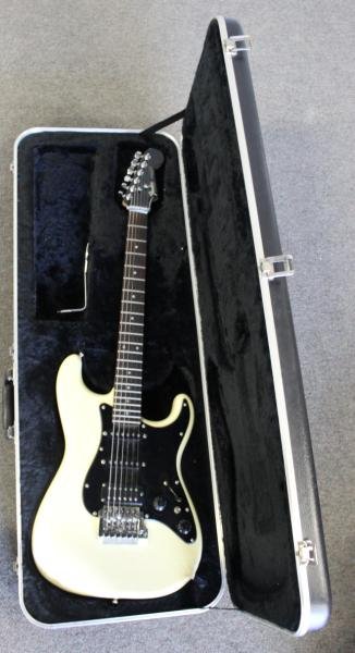 Fender, "Stratocaster " 6 String Electric Guitar.: Serial # E515096 (Japan). From a Larchmont, NY estate. Condition: Pearlised champagne finish. Tape reinforced over electric connection socket. In contemporary hard side Fender case.
