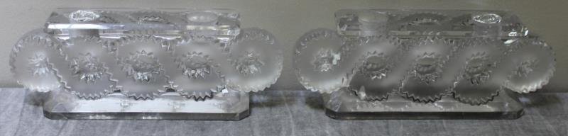 Pair of Lalique Candleholders.: Engraved Lalique France. Clear and frosted. From a White Plains, NY estate. Dimensions: 9" w x 2.25" d x 3.5" h. Condition: Good.