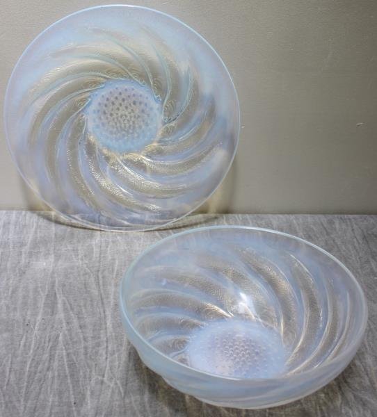 Lalique Opalescent Bowl and Underplate.: In a fish design. Molded R. Lalique in center of underplate. From a White Plains, NY estate. Dimensions: underplate - 12" diameter; bowl - 9.375" diameter x 3.5" h. Condition: Bowl with tiny fleabite