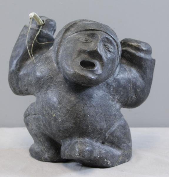 Inuit Carved Stone Sculpture of a Hunter with: Carved Bone Bow.From a Central Park West, NYC estate. Dimensions: 10" high x 9" wide x 6.5" deep. Condition: Good, appears to be missing second weapon - empty carved hole in one hand.